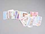 a lot of stamps on a table with a pair of scissors