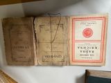 several old books sitting on top of a shelf next to each other