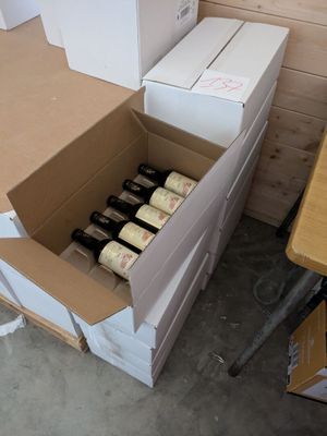 boxes of wine are stacked on top of each other in a room