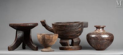 three wooden vases and a bowl are sitting on a table