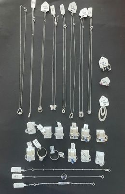 many different types of necklaces and bracelets displayed on a table