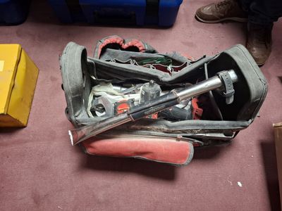 a piece of luggage sitting on the floor next to a pair of shoes