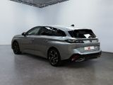 the rear end of a silver car in a white room