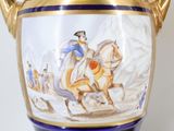 a vase with a painting of a man riding a horse on it