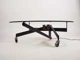an image of a coffee table on wheels with a glass top