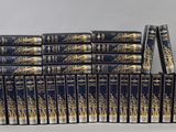 the twelve books are stacked on top of each other on a table