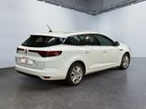 the rear end of a white car parked in a garage