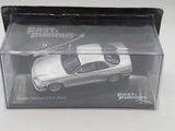 a white toy car in a clear box on a table