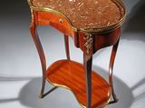 a table with a marble top and a shelf on it