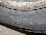 a close up of a tire on the side of the road