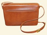 brown leather cross body bag with shoulder strap on a white background