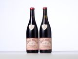 two bottles of wine sitting on top of a table next to each other