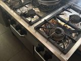 a stove with a pot on top of it in a kitchen