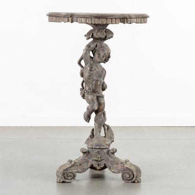 an antique wooden table with a statue on top of it