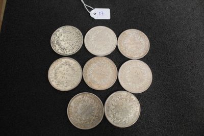 six different types of coins on a table with a price tag