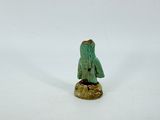 a small figurine of a person standing on a rock