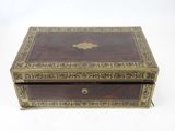 an old wooden box with a gold decoration on the lid