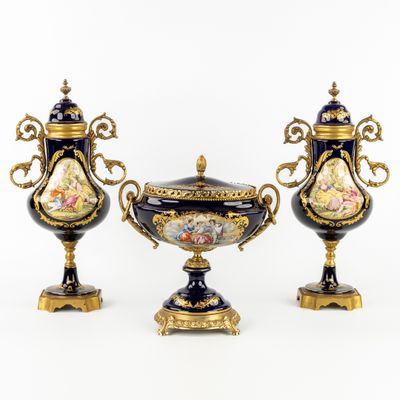 two vases with handles and a lid are sitting on a table