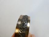 a person holding a ring that has a design on it