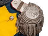 a yellow and blue uniform with a silver badge on it