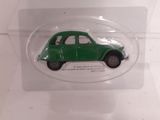 a small green car in a clear display case