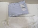a white shirt and a blue shirt sitting on a table