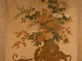 une image représentant un tableau montrant des fleurs dans un vase posé sur une charrette