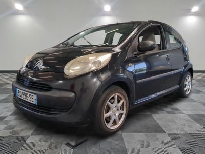 a picture of a small black car parked on a checkered floor