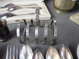 several spoons, forks, and spoon rest on a table