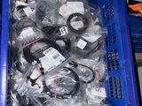 a blue crate filled with assorted electronics in it