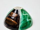 a picture of a green and black object on a white surface