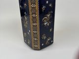 a blue vase with a gold border on it