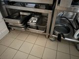 many pans and pans in the kitchen next to each other