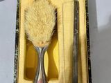 a box with a brush and a razor in it