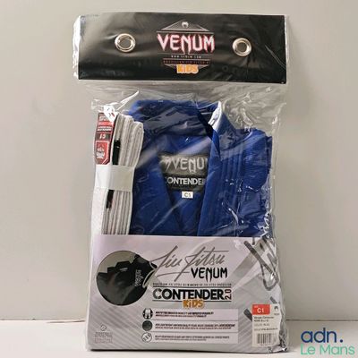 a package of items that include a blue shirt and a white pen