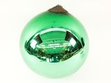 a green glass ornament with a wooden top