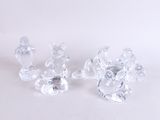 three crystal figurines sitting on a white surface