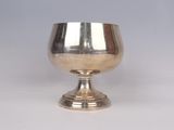 an antique silver goblet on a pedestal on a white background