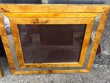 an old wooden picture frame with a glass window on the outside of it