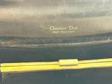 a black purse with a yellow handle on a table