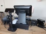 a desk with a monitor, speakers, and other electronics on it