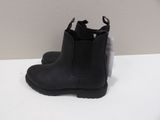 a pair of black chelsea boots on a white table