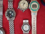a lot of watches that are sitting on a red surface