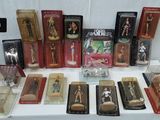 many different types of figurines displayed on a table