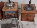 two old coffee grinders and a coffee grinder on a marble counter