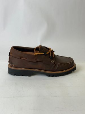 a close up of a pair of brown shoes on a white surface