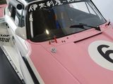 a pink race car that is on display in a museum