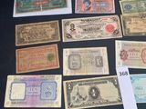 several different types of paper money sitting on top of a table