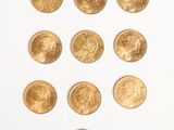 several gold coins arranged in the shape of a heart