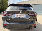 the rear end of a black bmw x4 parked in a parking lot